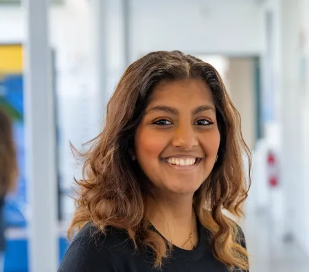Head and shoulders portrait image of Emy Godfrey, BA Philosophy and Politics student smiling looking at the camera.