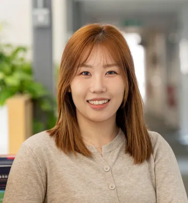 Head and shoulders portrait image of Fandi Zhou smiling at the camera.
