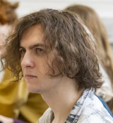 Head and shoulders portrait image of Luca Ringlet, BA Philosophy student looking to the left of the camera.