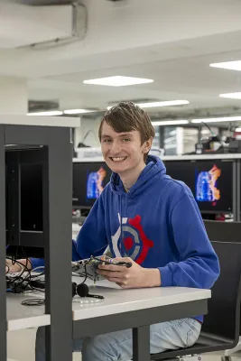 Leon Brindley sitting at an electronic engineering workstation.