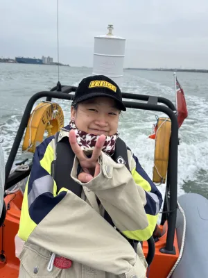 Global Marine Resource Management (MSc) student Jiao on a boat is smiling at the camera.
