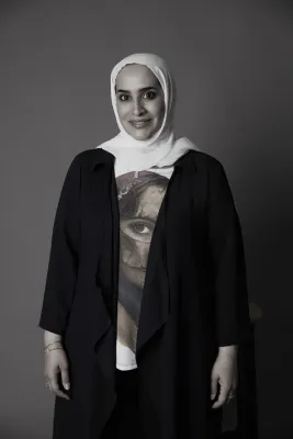 A black and white photo of Salwa looking at the camera