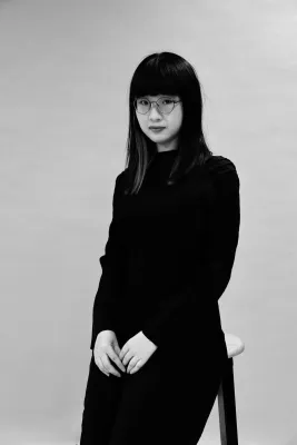 A black and white photo of Tianyu looking at the camera