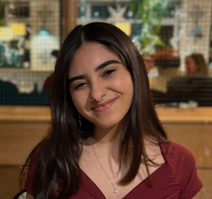 A portrait image of Anna smiling at the camera.