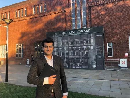 MA TESOL student, Sedigh standing out Hartley Library
