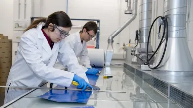 Two students at work in the testing and structures research lab