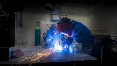 Students use welding equipment in the engineering design and manufacturing centre