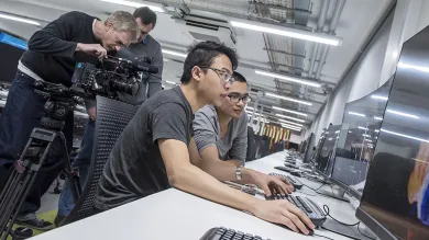 Two students working at a computer in the David Barron computing lab.