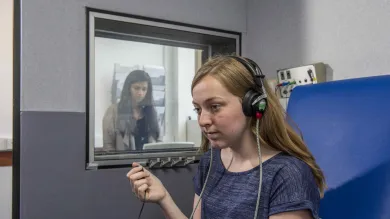 2 students conducting a hearing test.