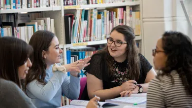 Group of history students in discussion in a library setting