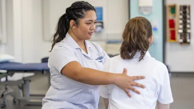 Physiotherapy students works with client in multifunctional skills room