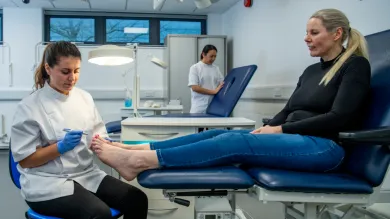 Podiatry student practising clinical skills with a client