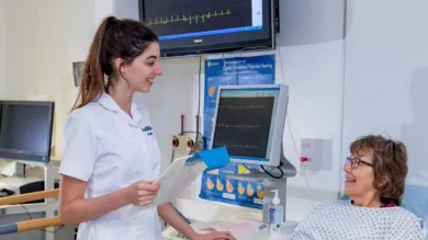 Cardiac physiology students with a patient in a clinical setting