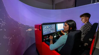 2 students use the flight simulator