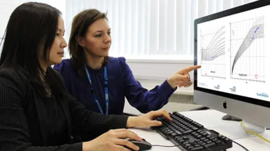 Clinical data researchers compare graphs on a computer screen