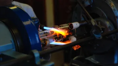 Glassblowing expert creating customised glassware in a workshop