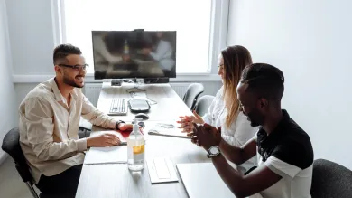 three people in discussion in business meeting room 