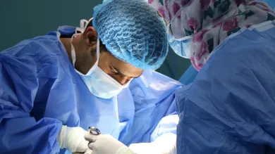 Image of two surgeons performing surgery. 