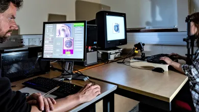 A University researcher uses an eye-tracker device to record and analyse eye movements of a research participant