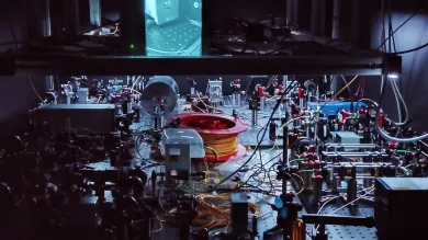 An optical table with components such as lasers, tapered amplifiers, optical fibers and various free-space optics and optomechanics. 