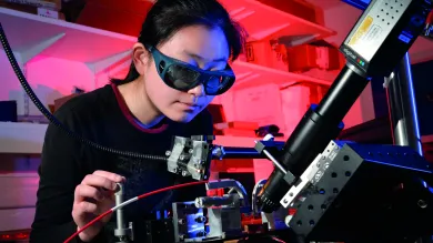 Person in laboratory using laser equipment