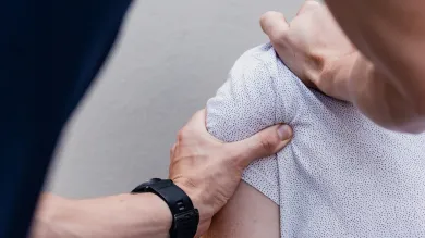Unsplash image of a physiotherapist manipulating a patient's shoulder muscles