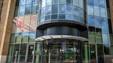Exterior view of the modern glass-fronted building that houses the Institute of Developmental Sciences.