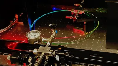 A gas-filled hollow core optical fibre scatters a spectrum of colours. 