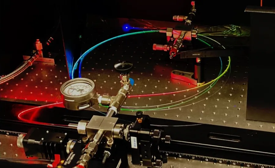 A gas-filled hollow core optical fibre scatters a spectrum of colours.