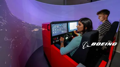 Two students use the Boeing flight simulator
