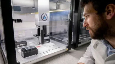 Scientist looking at lab equipment