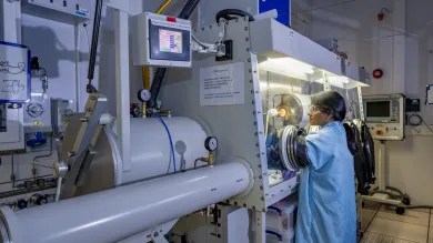 A woman near CVD Glovebox with Furnace  