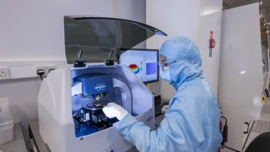 A person working at Bruker Dektak XT Stylus profiler equipment