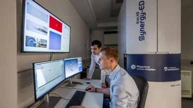 Two chemical technicians reviewing Electron Diffraction data on a computer screen at the NEDF facility