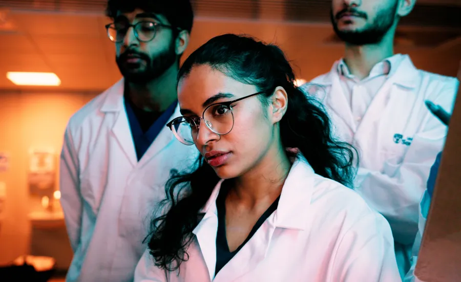 A group of students wearing lab coats.