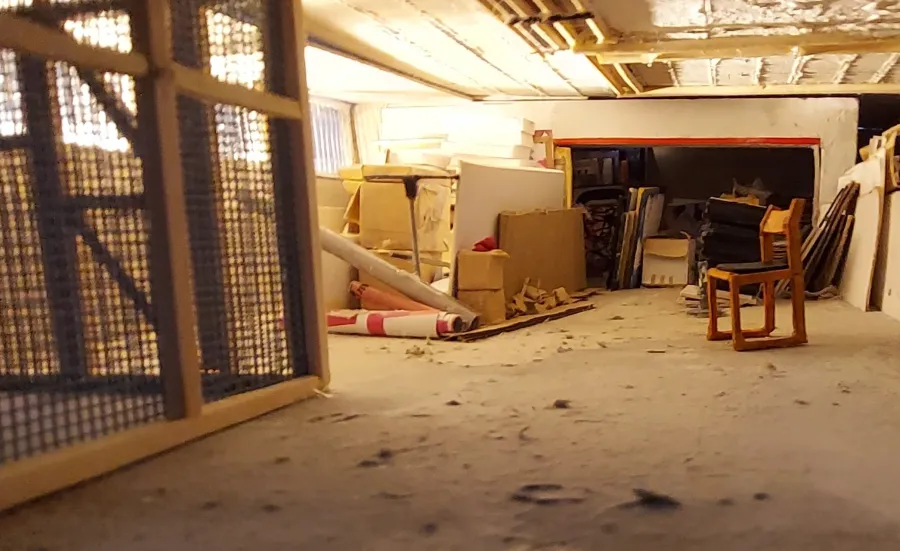 The storage space at Winchester Gallery, with a chair in the centre of the room.