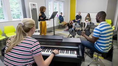 Students playing instruments in the Glen Eyre main building music room.