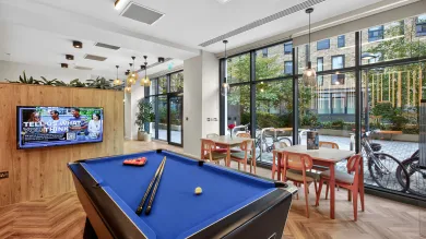 The games room at Capital House accommodation. It features a large pool table.