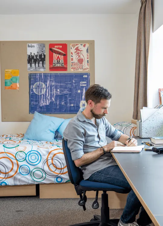 A student sitting in his studio flat.