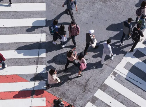 People crossing a busy pedestrian crossing