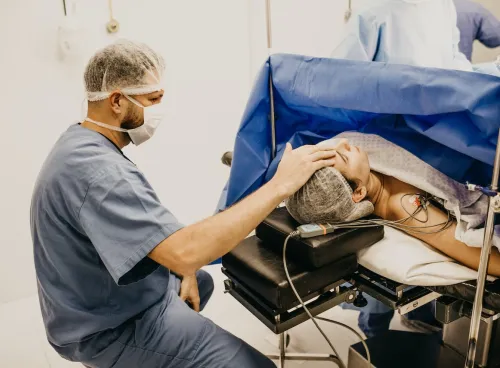 Image of a nurse looking after a patient during surgery. 