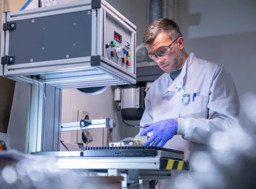 Scientist carrying out experiment using the facilities equipment