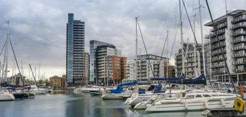 Yachts in Ocean Village Marina, showing skyline on a cloudy day. 