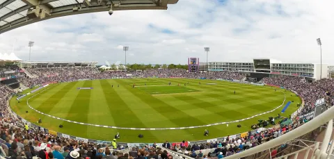 Wide view of Ageas Bowl stadium, with crowd watching cricket.