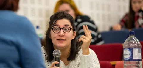 Student talking with microphone during a lecture.