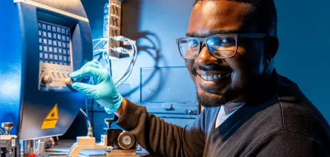 A student working in a workshop, at a desk.