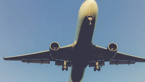 A large passenger plane flying close overhead