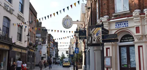 View of a typical UK town highstreet with shop fronts and bunting