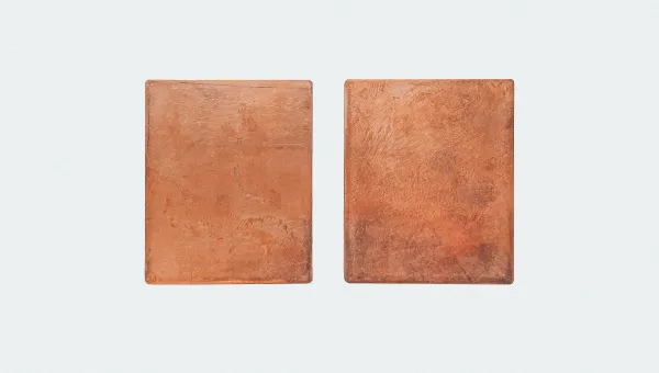Two rectangle shapes made of copper placed on a white background