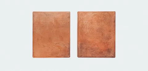 Two rectangle shapes made of copper placed on a white background